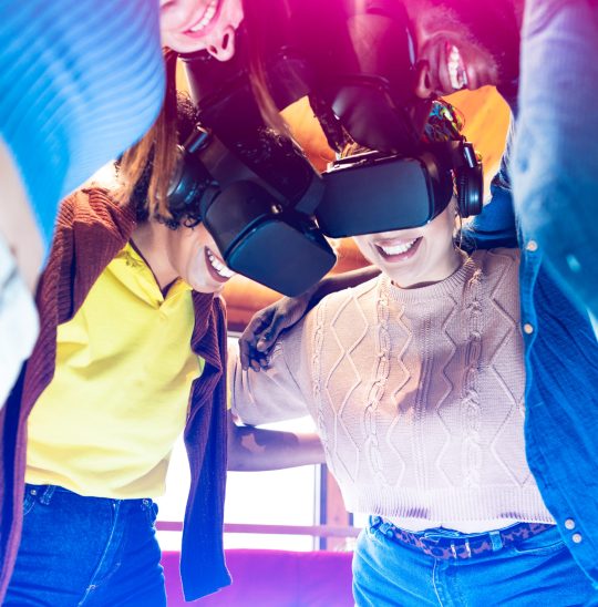 Enthusiastic friends  playing with vr glasses while embracing to